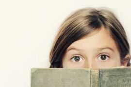 Girl looking over an old book