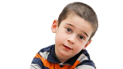 Young boy tilting his head
