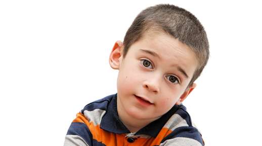 Young boy tilting his head