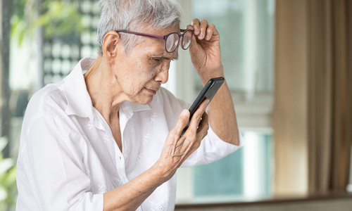 Woman straining to look at phone