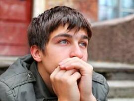 Young man sitting on steps