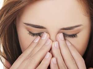 Woman experiencing eye pain