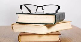 Reading glasses on a stack of books