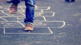 kid playing hopscotch