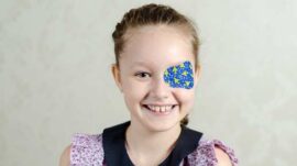 Young girl wearing an eye patch