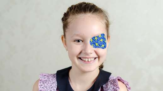 Little girl wearing an eye patch