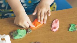 Kids hands playing with clay