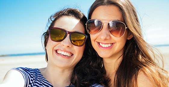 Women wearing sunglasses on a beach