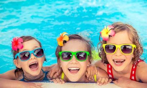 Kids with sunglasses in a pool