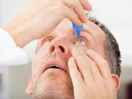 Man putting in eye drops