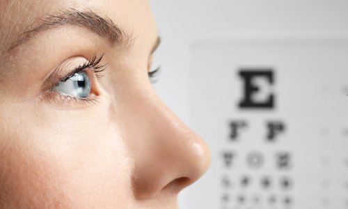 Woman profile with eye chart in the background