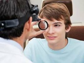Boy having his eye examined