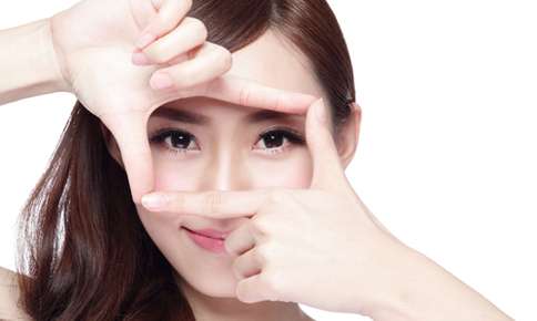 Woman framing her eyes with fingers