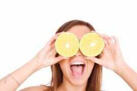 Silly woman with orange slices over her eyes