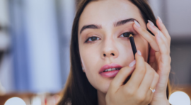 Woman applying eye makeup