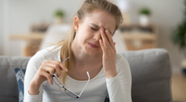 Woman rubbing her irritated eyes