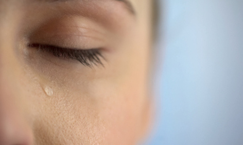 Woman with tear falling from eyes